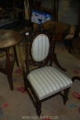 A charming Walnut framed child's side Chair having mirrored twist back supports and fretworked