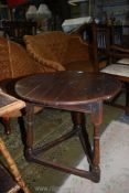 An early peg joyned dark Oak circular tavern Table standing on three turned legs with perimiter