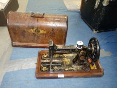 A bentwood cased Singer sewing machine.