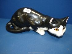 A black and white Staffordshire cat by 'Just Cats & Co' having glass eyes, 14'' long x 5 1/2'' high.