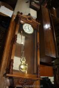 A Mahogany cased Vienna type Wall Clock having a bi-metal suspended pendulum and double weight