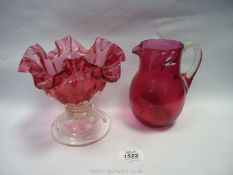 A cranberry jug and a cranberry bon-bon dish having fluted edge.