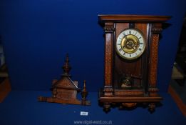 A German made eight day wall Clock with floral inlaid motif detail to the side panels at the front