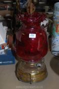 A large brass church Oil Lamp with cranberry glass shade, single wick burner,