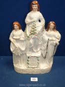 A Staffordshire flatback figure 'Faith, Hope and Charity', some crazing and damage,