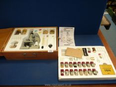A Young Scientist Salters Merit microscope set in wooden case to include pickled frog, crab,