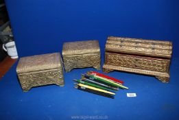 Two brass covered jewellery caskets and a painted wood caskets encrusted with multi coloured glass