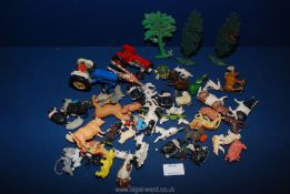 A quantity of plastic farm animals, two tractors a/f, etc.