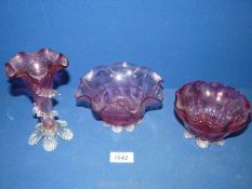 Two cranberry glass fluted bowls and a cranberry fluted vase.
