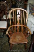 An appealing solid Elm seated stickback Elbow Chair having a crinoline stretcher and a fretworked