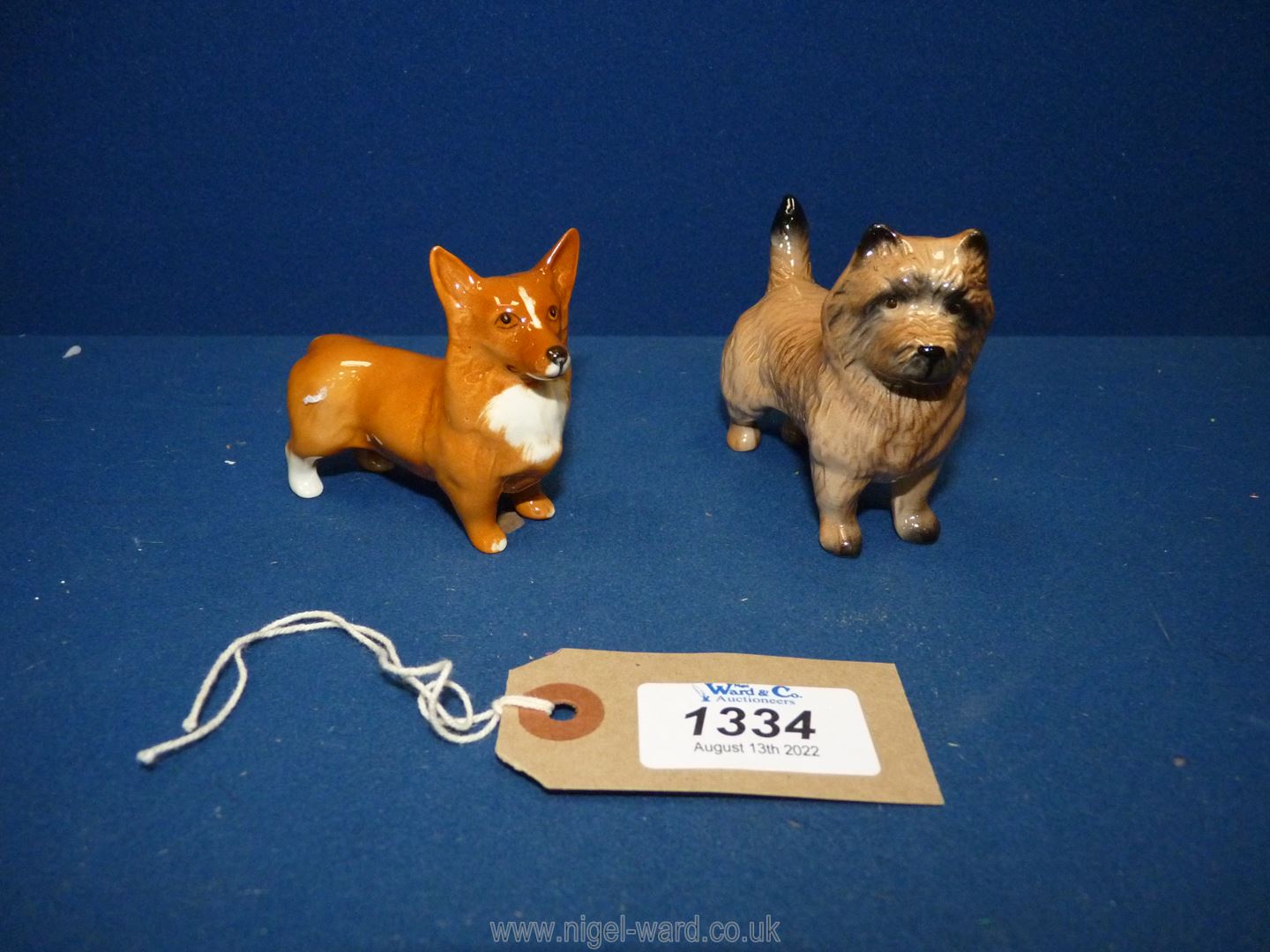 Two Beswick dogs including a white and tan Corgi 2⅔" tall and a Cairn terrier 2¾" tall.