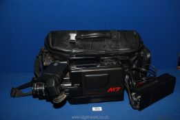 A Panasonic VHS movie Camcorder with video AC adaptor VW-AM7, in black carrying case.