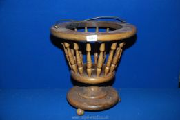 A lightwood circular jardiniere Stand with bobbin turned spindle sides,