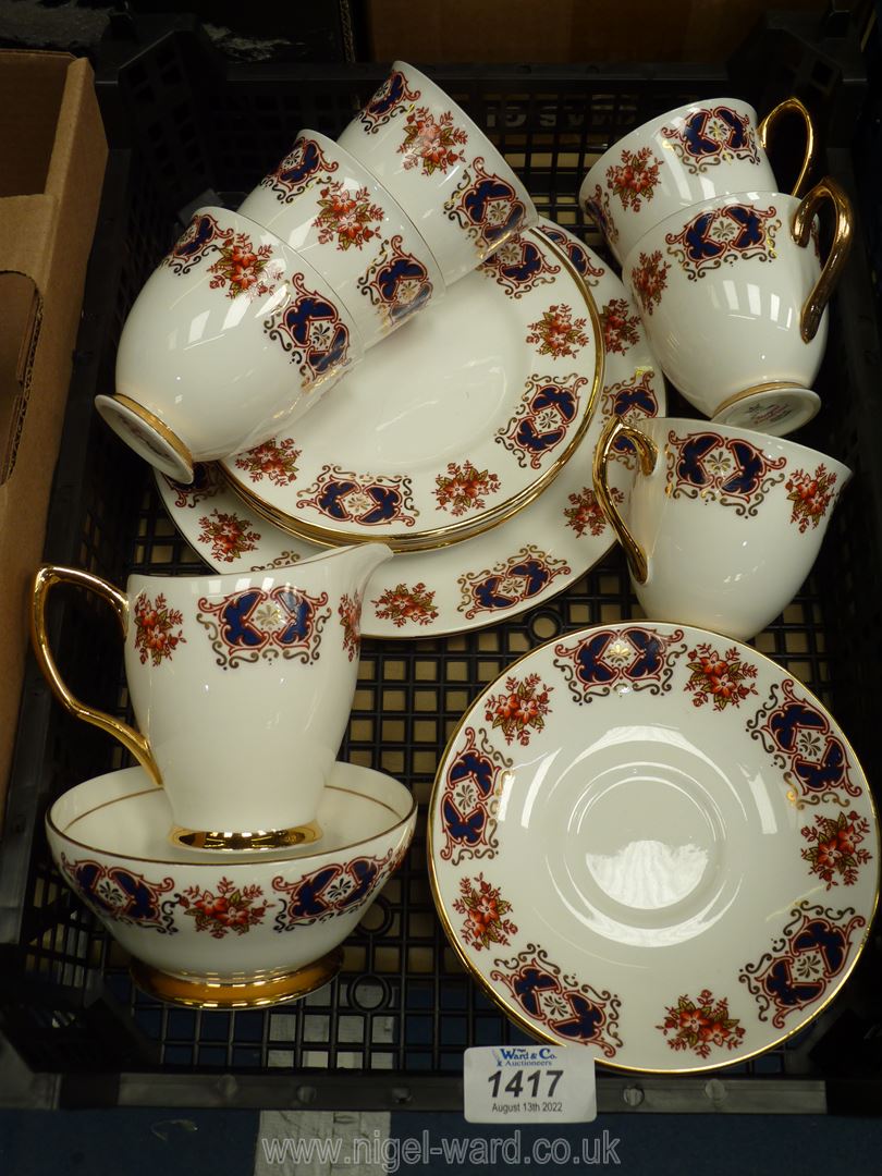 A Royal Imperial tea set for six with panels of blue, red and gold with sprays of flowers,