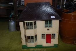 A mid-century tinplate Doll's house with some items of furniture, etc.