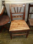 A peg joyned Mahogany solid seated kitchen Chair of Georgian design with unusual design back with