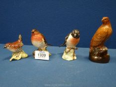 Four Beswick birds to include a robin, wren (sticker present,) stonechat,