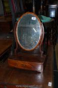 A small Victorian oval Mahogany veneered swing mirror with curved drawer to base, 21'' tall.