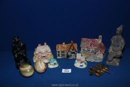 Two onyx eggs, a coal miner ornament made out of coal, a Tey pottery house, and other houses,