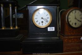 A black marble mantle Clock, with pendulum and key, 5 3/4" x 11" tall.