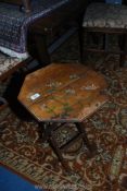 A darkwood octagonal topped occasional Table having crossed legs,