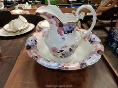 A Wood & Son jug (11 1/4') and washbowl (16'' diameter) in cream with pink and blue flowers.