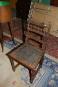 An Oak finished arts and crafts side Chair having turned spindles and acorn finials to the back,