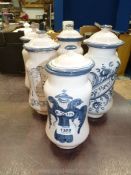 Six blue and white apothecary jars with lids, tallest jars 10'' high.