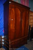A contemporary Mahogany double Wardrobe having a pair of opposing arched flame Mahogany panelled