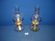 A pair of oil Lamps with clear glass bases/reservoirs, 11 1/2" tall.