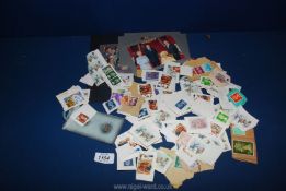 A small quantity of English stamps, postcards of the Royal Family, mixed stamps,