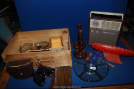 A quantity of miscellaneous in a wine crate including Regent 8x30 binoculars, treen candlesticks,