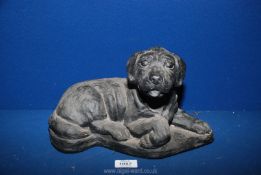 A heavy doorstop in the shape of a dog, 7 1/2'' x 12'' long.