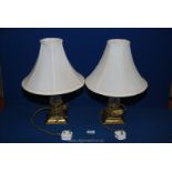 A pair of Lamps with glass and brass base, having cream shades, 18" tall.