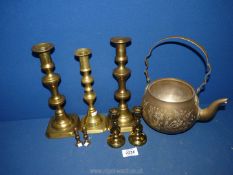 A quantity of brassware to include various candlesticks and a large teapot (lid missing).