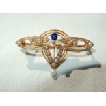 A 15ct Art Nouveau style brooch with seed pearls and blue stone sapphire (?) in leather box.