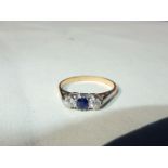 A 9ct gold lady's ring set with a small central sapphire and a pair of small diamonds (3 medium