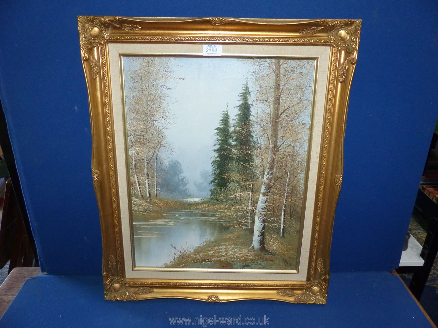 An unsigned Oil on canvas in a gilt frame of a River flowing through woodland, 21 1/4" x 25 1/2".