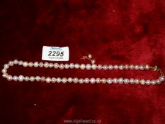 A pearl necklace and earrings set.