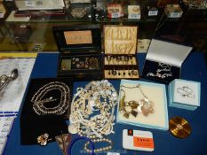 A quantity of costume jewellery to include; beaded necklaces, buttons,