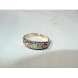An 18ct gold ring set with 5 small diamonds (do not test as diamonds), very small,