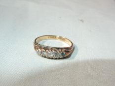 An 18ct gold ring set with 5 small diamonds (do not test as diamonds), very small,