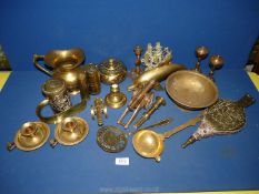 A quantity of brass including a jug, spoons, dolphin ornament, large show horn, chamber sticks, etc.