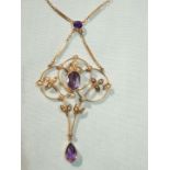 A pretty 9ct gold Art Nouveau style pendant with seed pearls and purple stones,