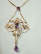 A pretty 9ct gold Art Nouveau style pendant with seed pearls and purple stones,