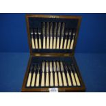 A cased set of twelve dessert Knives and forks with decorated epns blades.