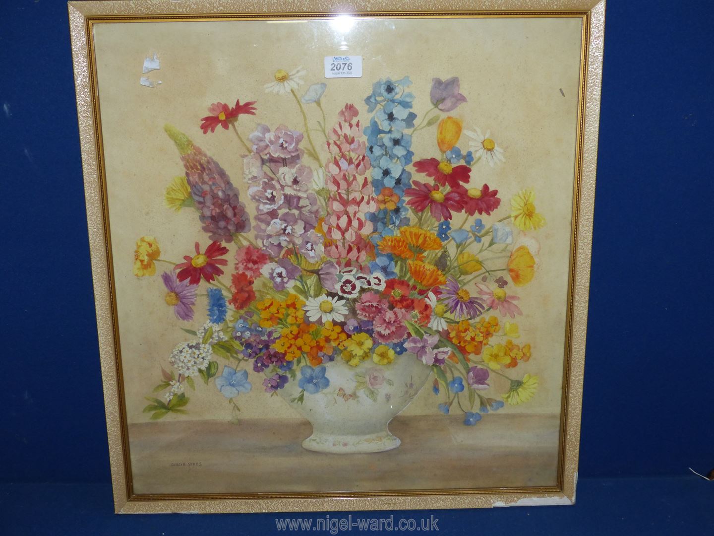 A framed watercolour depicting a still life of flowers, signed ,lower left 'Dorcie Sykes'.