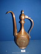 A Middle Eastern copper ewer/pitcher, heavily engraved with mythical beast depicted on either side,