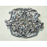 A large silver Brooch/pendant with decoration of laurel wreath, mandolin and figures,