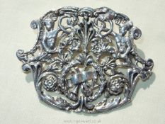 A large silver Brooch/pendant with decoration of laurel wreath, mandolin and figures,